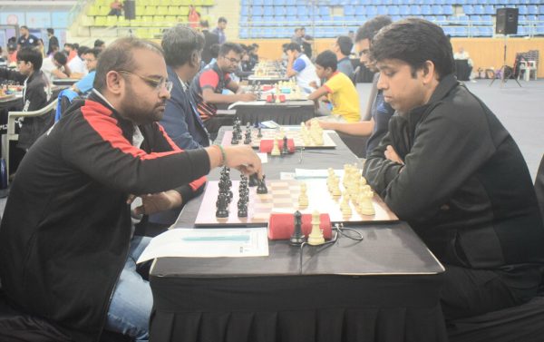 Abhijeet Gupta of PSPB(red and black shirt)(black pieces) making move against Ajay Rai from DASCB(Black shirt)(white pieces) in the 2nd round at Boxing Hall, Shree Shivchhtrapati Krida Sankul Mahalunge Balewadi